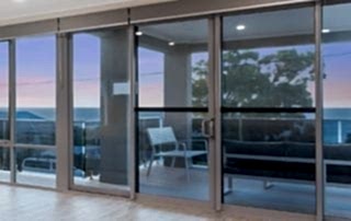 Aluminium stacker doors opening out into the balcony of Perth home in the suburbs