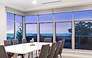 Aluminium awning windows used in the dining area of a modern Perth with a view of the beach