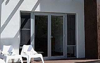 Grey aluminium French doors installed at a Perth home leading to the pool area