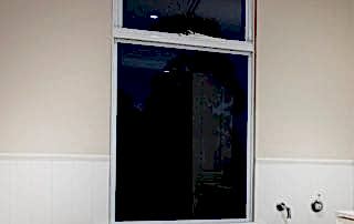 White residential awning window installed next to bath tub in Perth home